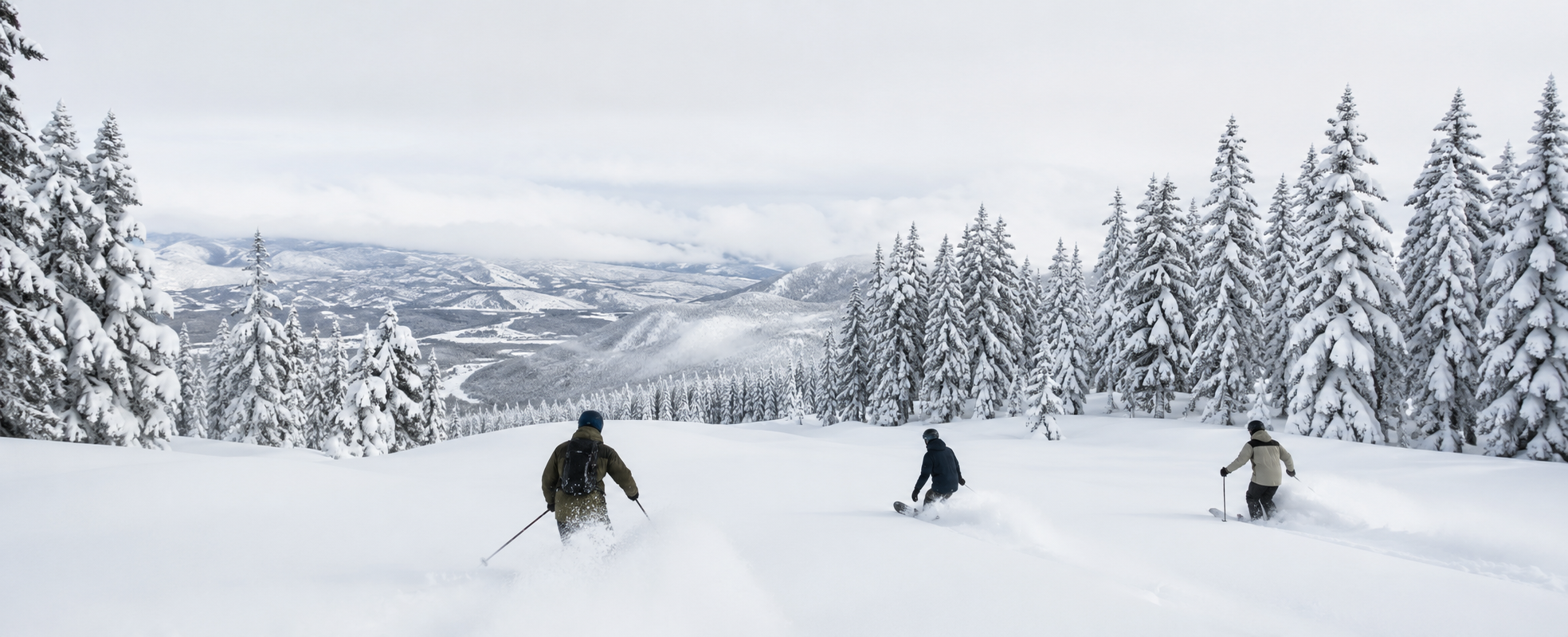 Instructors skiing and snowboarding powder in Japan